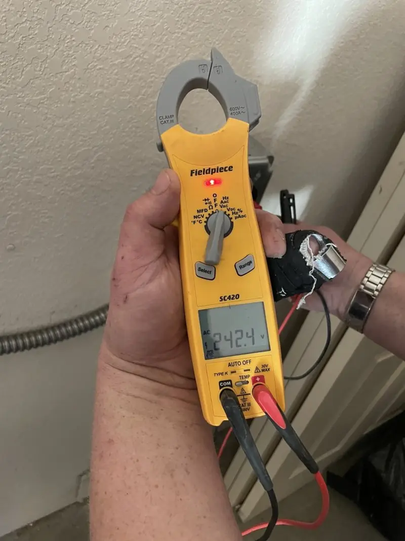 Voltage testing with clamp meter during Outlet Installation in Gilmanton